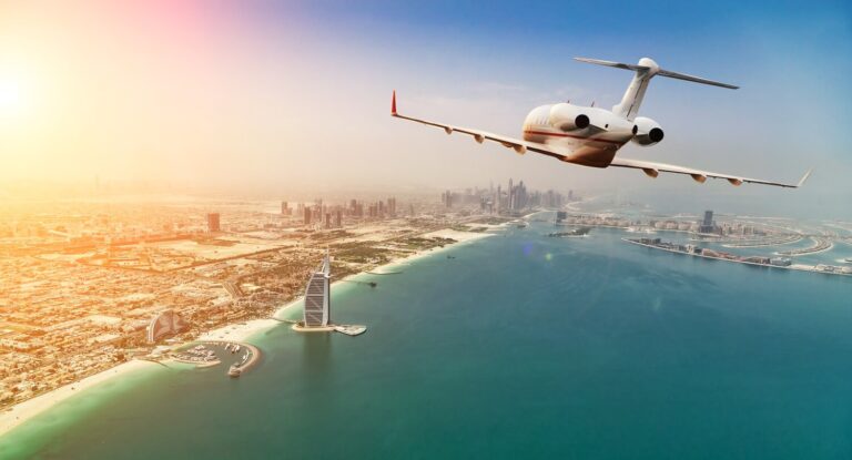 private jet flying over dubai city