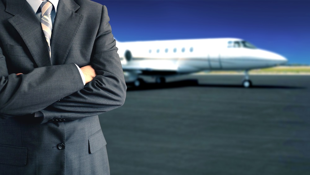 Corporate Travelers Businessman in front of private jet