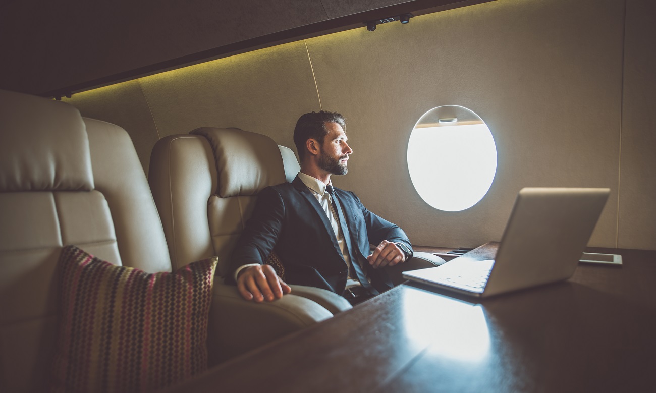 Businessman flying on his private jet