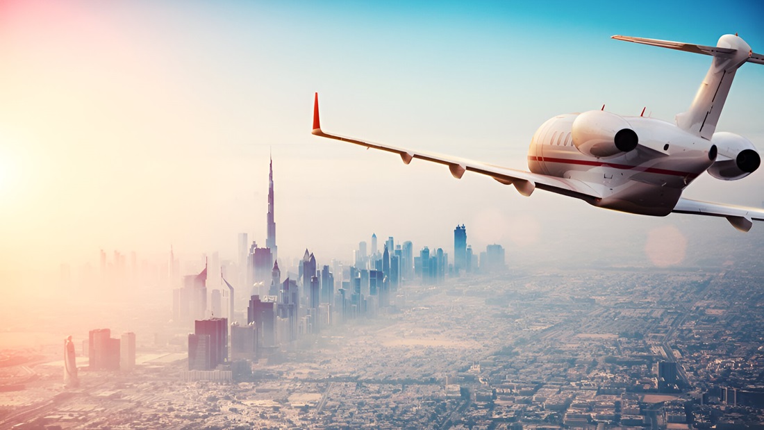 Private jet plane flying above Dubai city