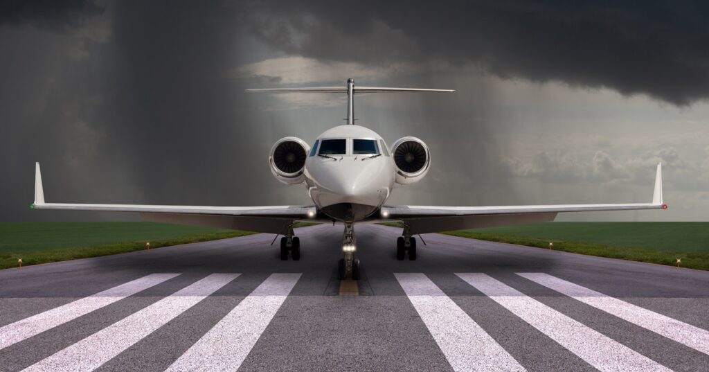 private jet on the runway with rain the background