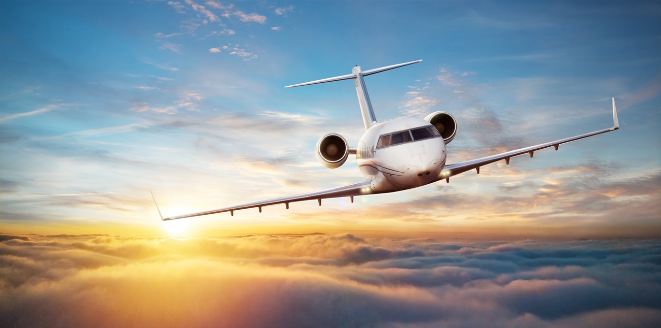 Luxury private jetliner flying above clouds