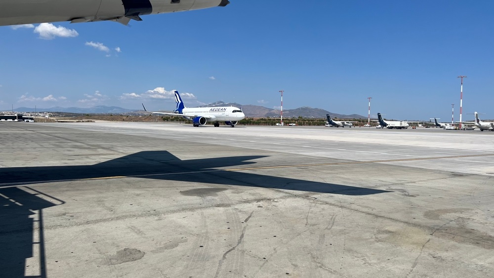 Traffic of airplanes, buses and people in Mykonos Airport during summer season