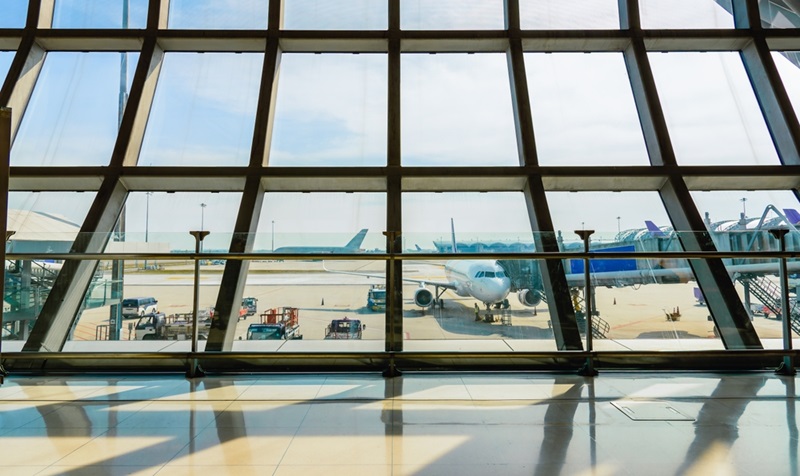 Airport terminal glass window with view of airplane, Suvarnabhumi airport departure hall for travel and transportation concept