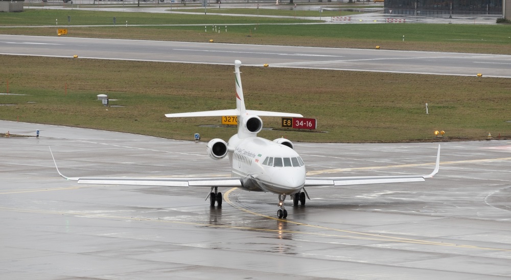 Government Dassault Falcon 900EX aircraft is taxiing in the rain after the world economic forum in Davos