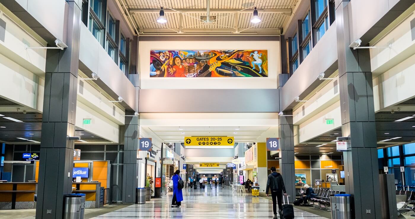 Travelers walk through an airport terminal at the Bergstrom International airport in Austin,Texas