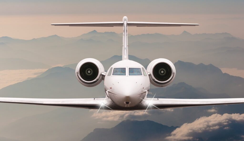 airplane fly over clouds and Alps mountain on sunset