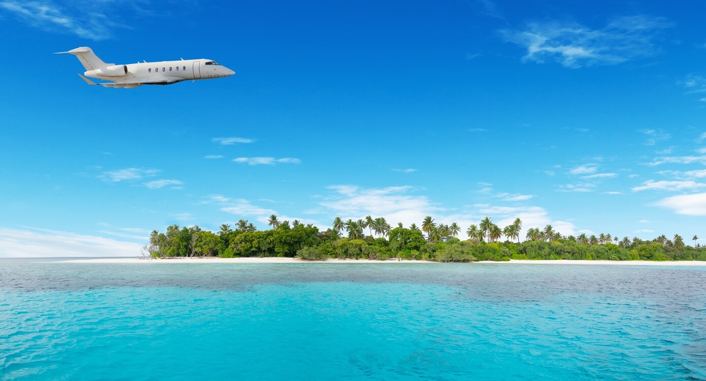 airplane flying over nonsettled tropical island