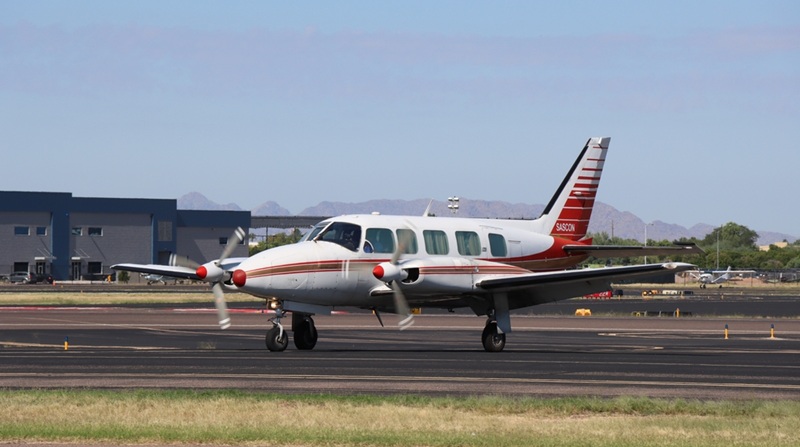 Private Aircraft PA-31-350 taxiing on taxiway D at Falcon Field Airport on a clear summer day