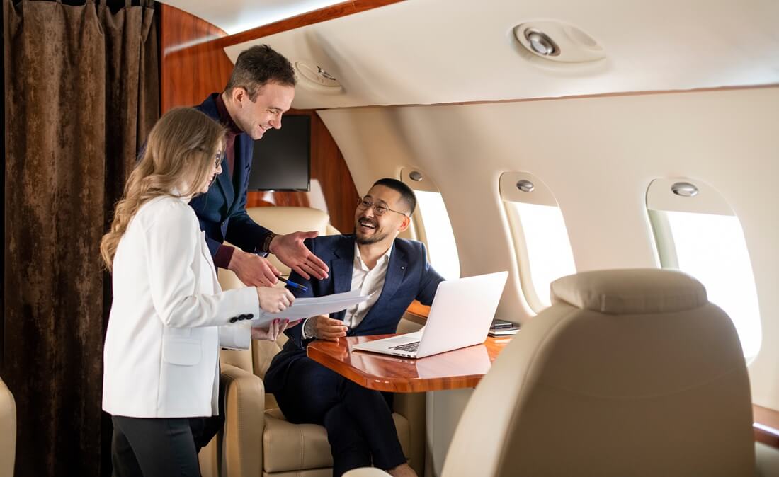 group of people at meeting fly in private jet and discuss business deal, the boss and colleagues in the plane