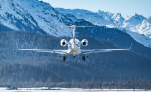 Business jet landing at the alpine airport in Samedan in the engadin valley in the Swiss alps