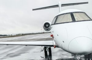 small white airplane sitting on top of an airport runway