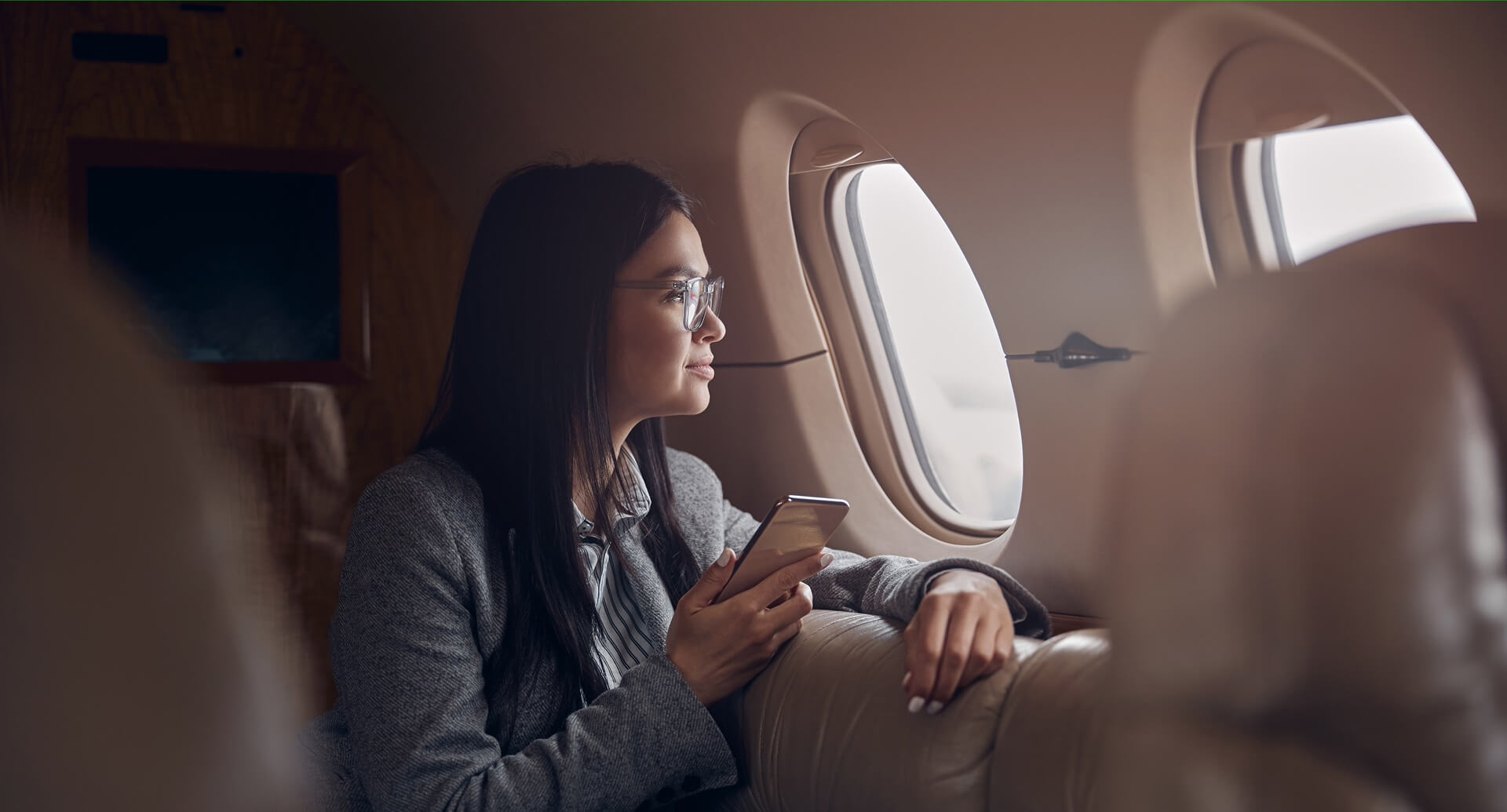 Happy smiling beautiful business woman in private jet