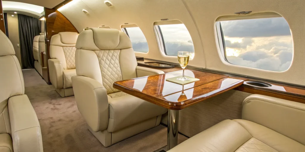 Private aircraft interior with plush seating and elegant table.