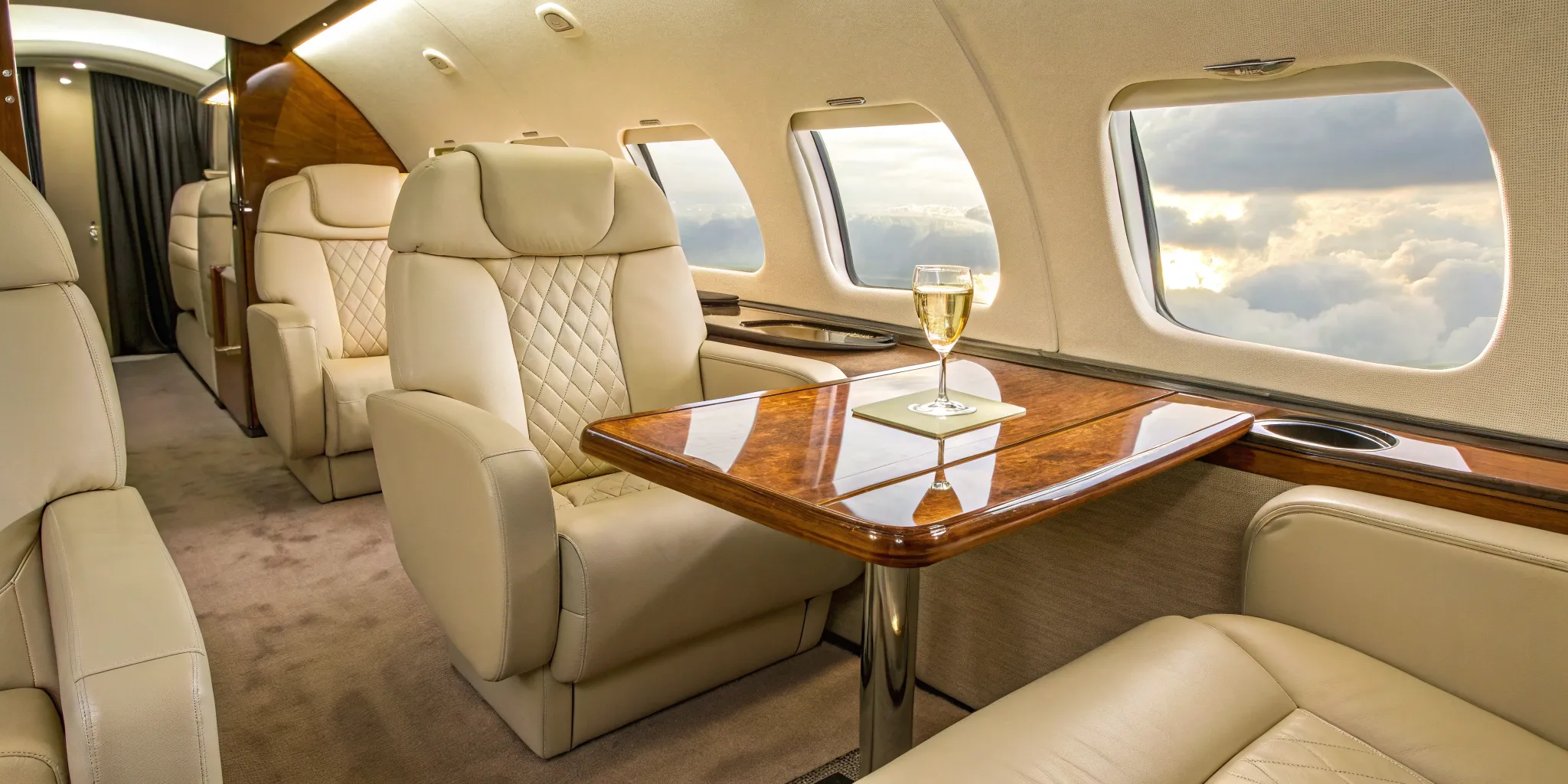 Private aircraft interior with plush seating and elegant table.
